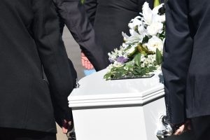 A group of people carrying a casket 